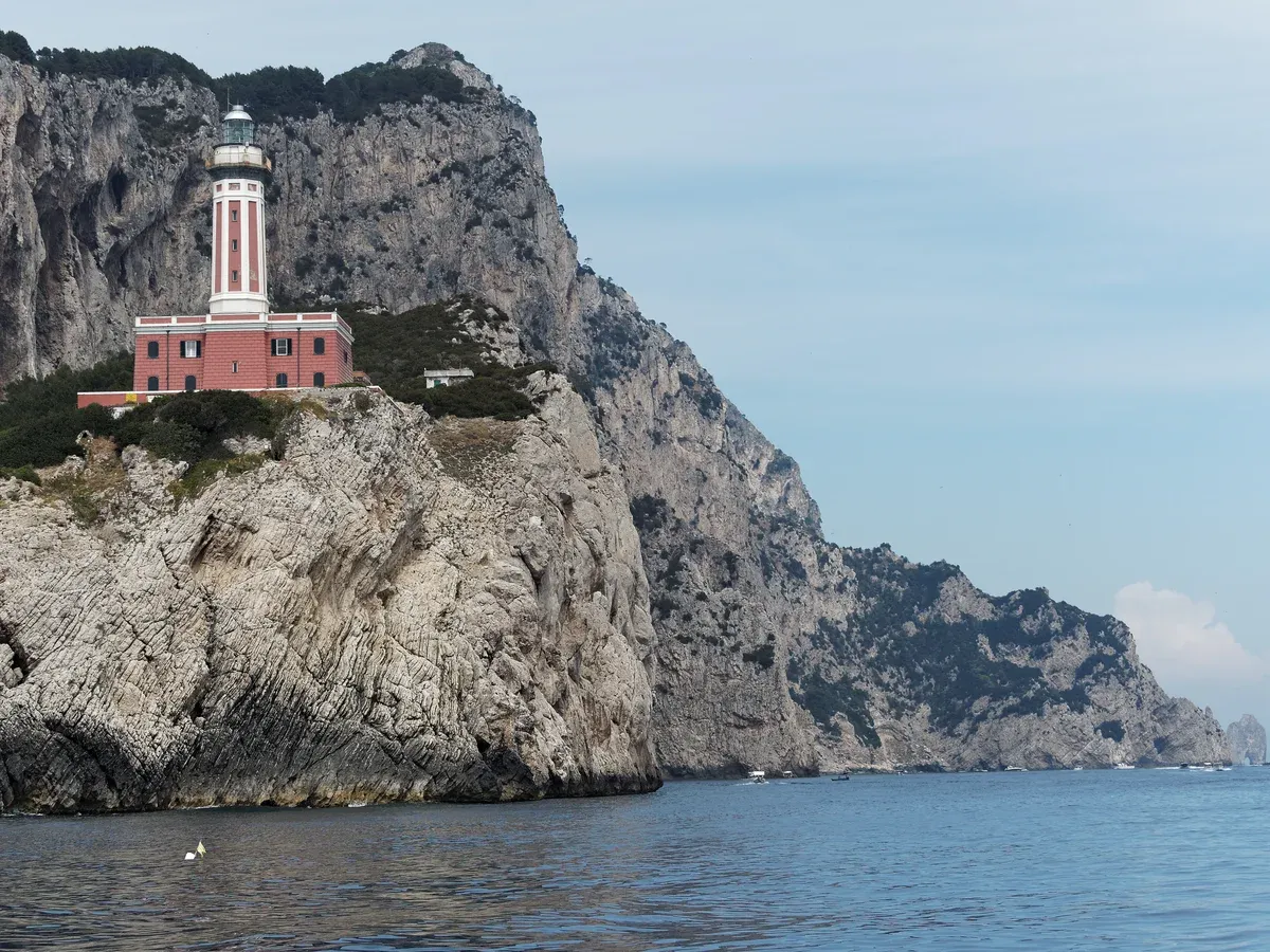 The Punta Carena lighthouse on the southwest coast of Capri passed at the end of a private boat tour, Italy